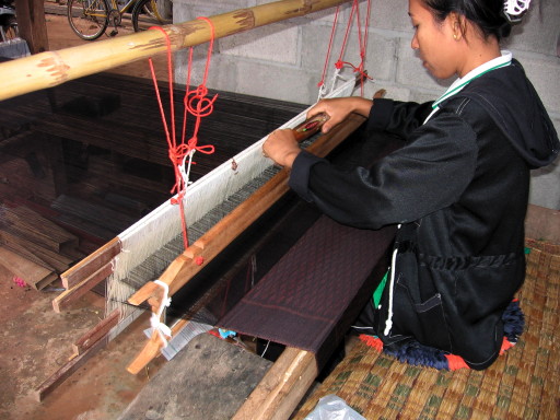 woman weaving silk in korat province